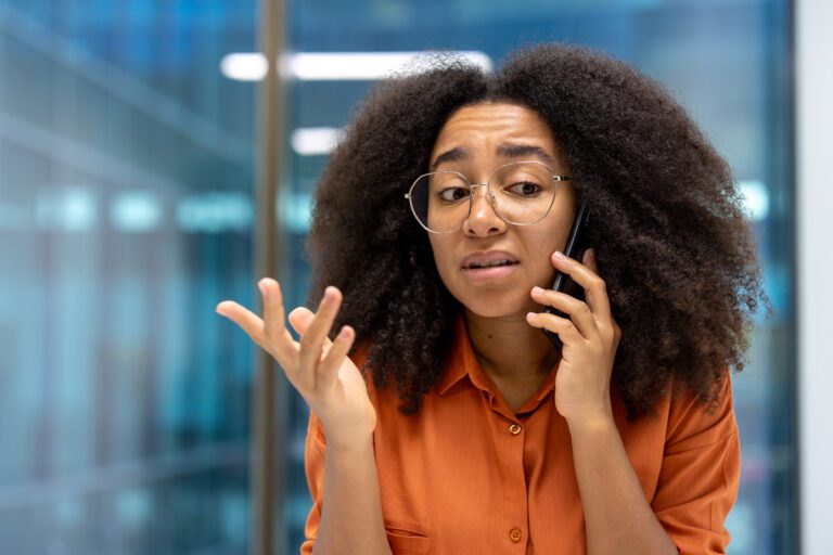 serious-woman-talking-on-the-phone-close-up-of-bu-2025-03-25-11-29-03-utc (1)